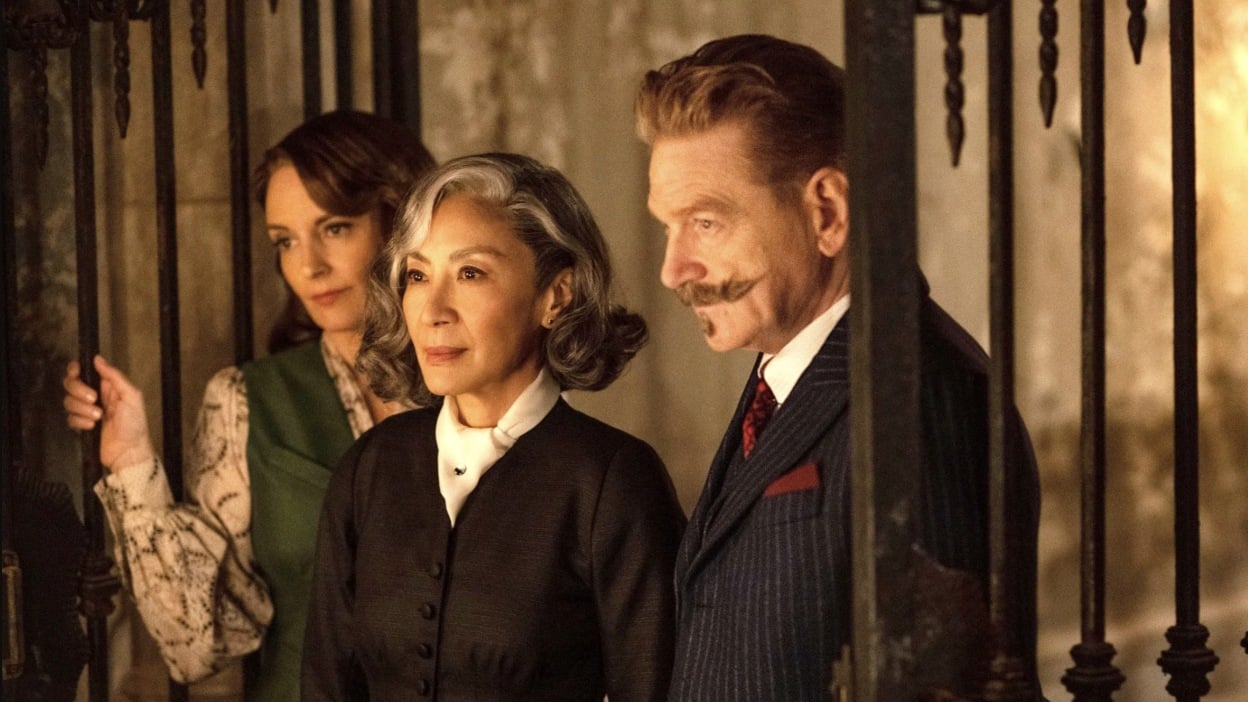 Ariadne, Joyce, and Poirot look concerned in a scene from A Haunting in Venice