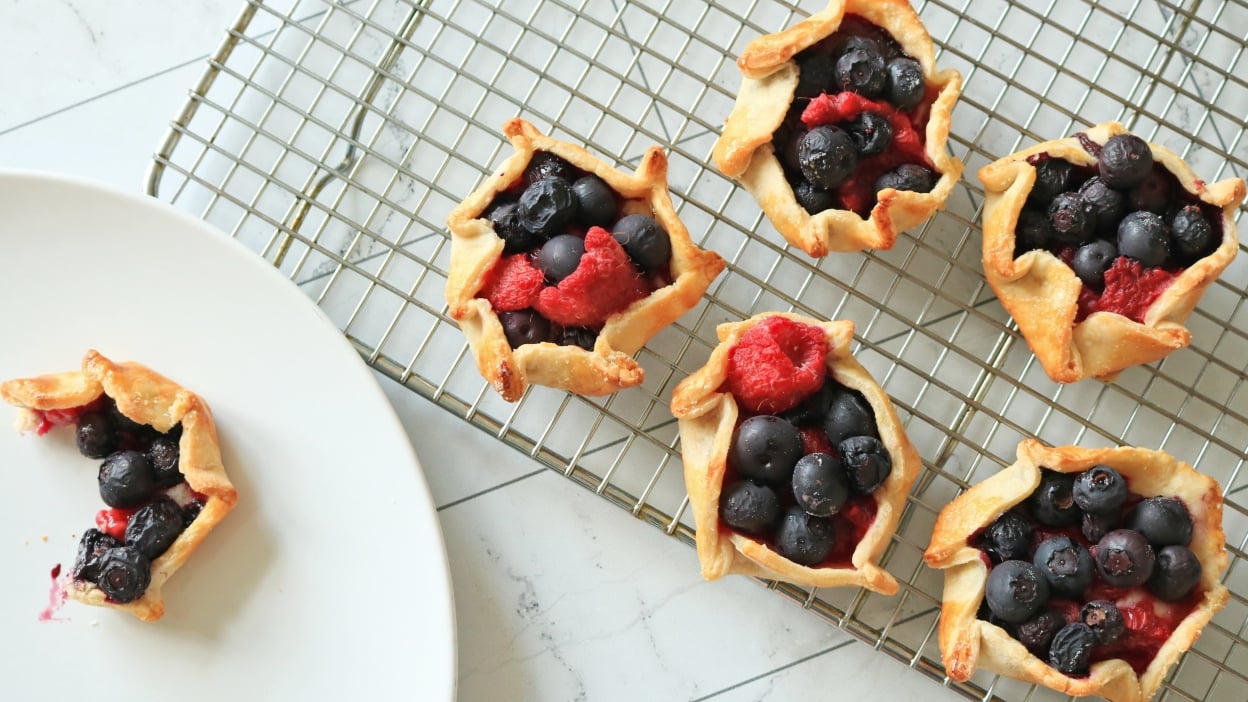 Mini berry galettes on a cooling rack.