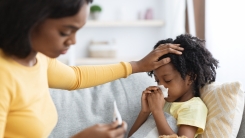 Mom taking kid's temperature