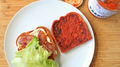 A BLT sandwhich open on a plate