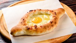 A khachapuri bread on a cutting board