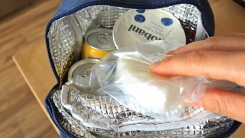 hand putting a cooler pack in a lunch box