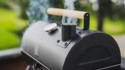 A black smoker outdoors.