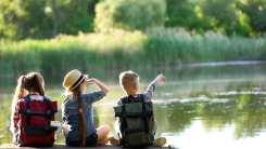 little kids sitting on pier in summer 