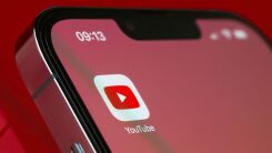 The YouTube app logo on an iPhone home screen