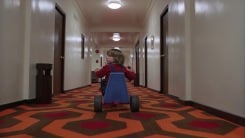 Danny on a tricycle in a still from The Shining