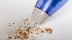 A vacuum cleaning crumbs on white background.