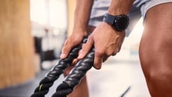 man holding a rope attachment in the gym