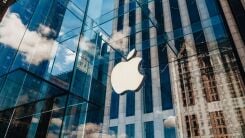 The Apple logo as a sign on a glass office building