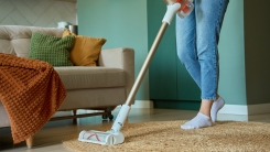 woman vacuuming a living room 