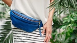 A woman wearing a blue fanny pack.