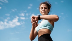 woman outside checking her fitness watch