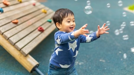 Little boy playing with bubbles