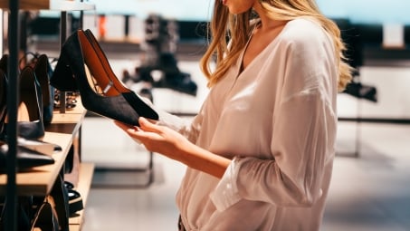 Woman shopping for shoes in store