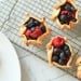 Mini berry galettes on a cooling rack.