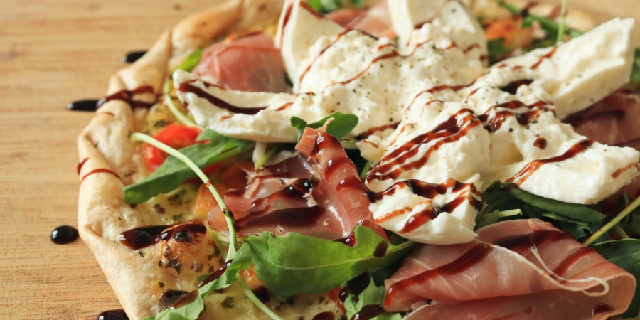 Pizza with burrata on top and some balsamic glaze.