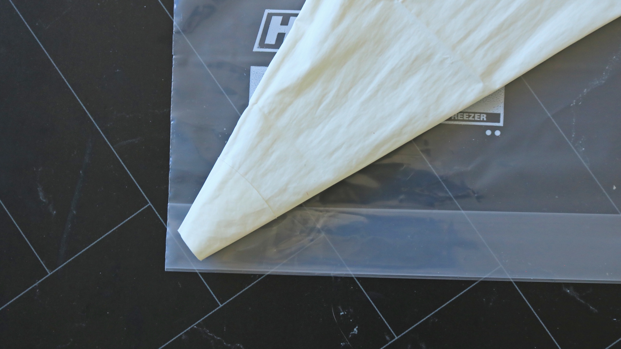 A piping bag on top of a plastic storage bag.