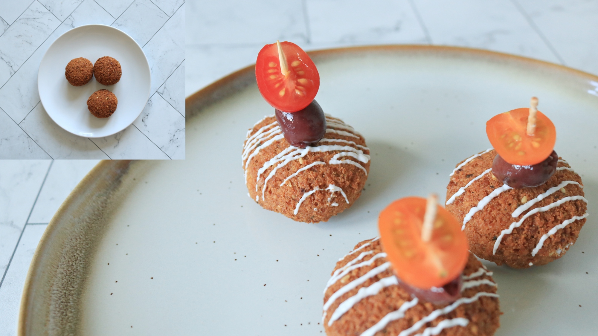 Falafel balls with tomato and olive toothpick on top.