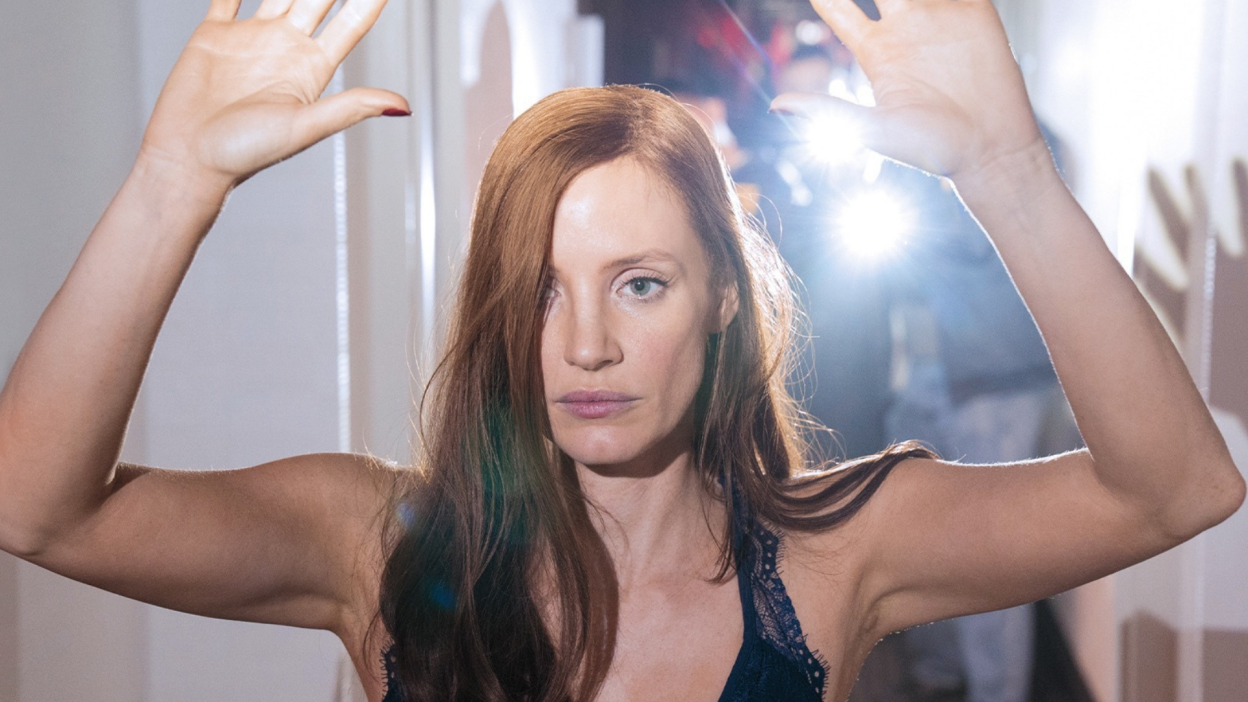 Jessica Chastain holds up her arms in a scene from Molly's Game