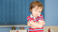 young boy, angry with arms crossed