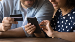 Couple adding credit card to phone.