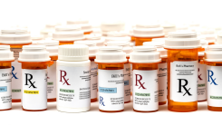 A collection of pill bottles against a white background