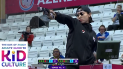 A screenshot of Kim Yeji firing a pistol in competition while wearing an aiming apparatus over her eye