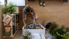 Woman cleaning and tidying up blankets