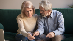 Stressed older couple going over paperwork