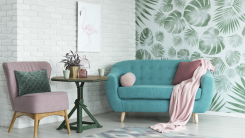 90s-inspired living room decor with mauve and green furniture and one wallpapered wall