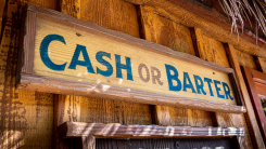 old-fashioned wooden sign that reads "cash or barter"