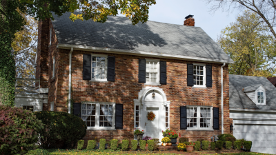 house with a large shade tree blocking the sun on one side