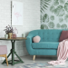 90s-inspired living room decor with mauve and green furniture and one wallpapered wall