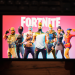 person holding smartphone with fortnite on screen