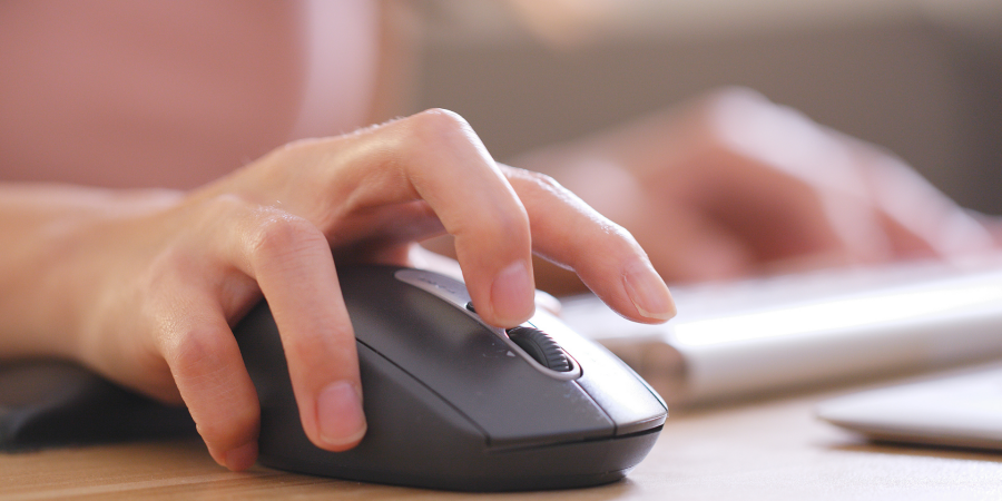 A person with a raised finger about to press the middle mouse button