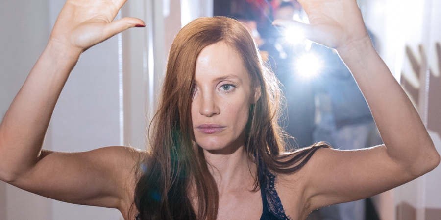 Jessica Chastain holds up her arms in a scene from Molly's Game